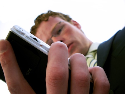 Young Businessman with Smartphone in Hand